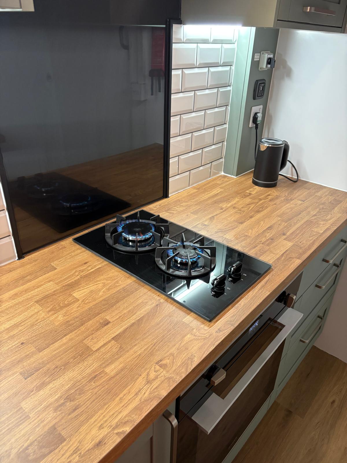 Gas hob lit with blue flames